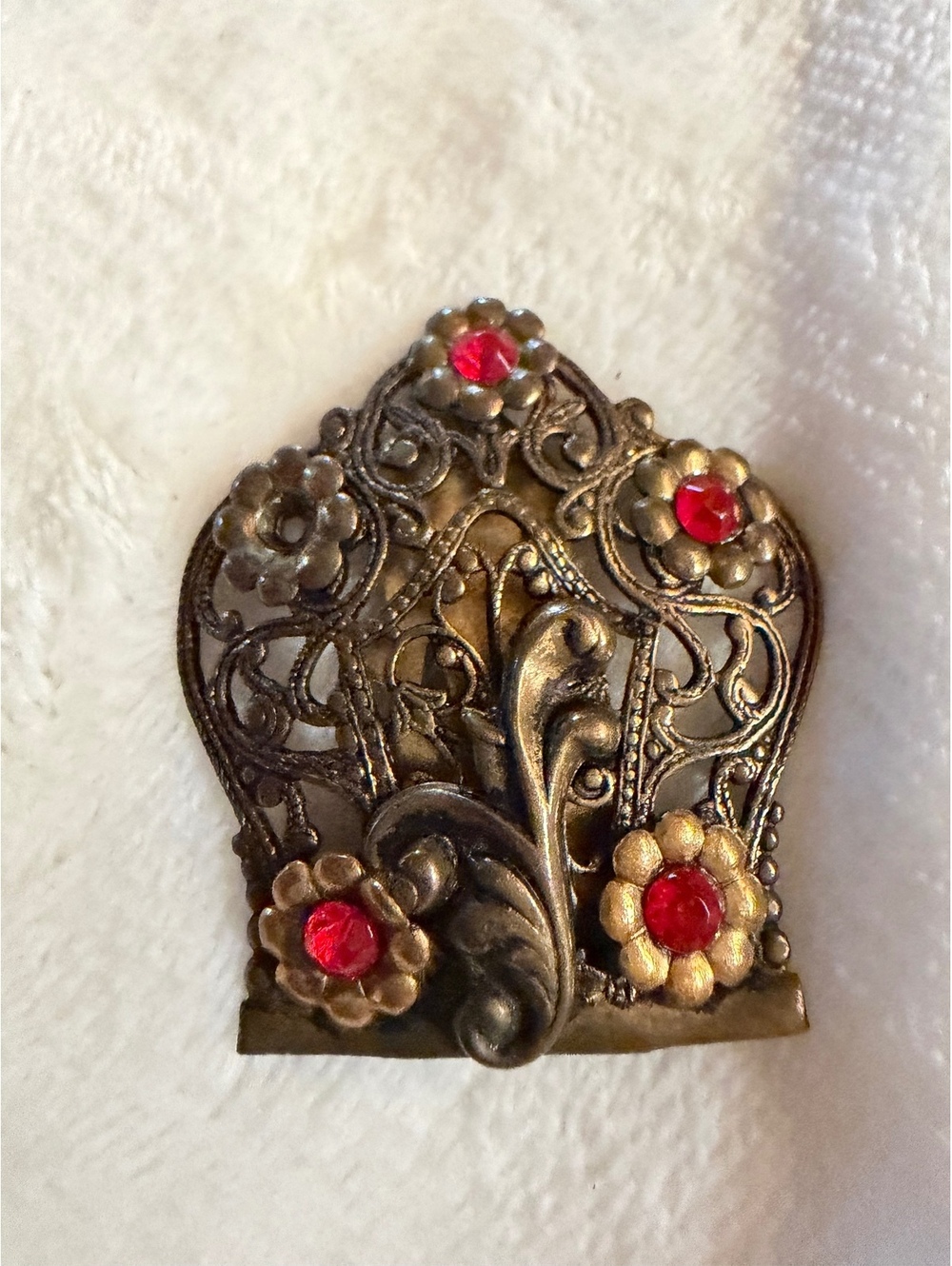 vintage dress clip with red rhinestone and floral arrangement